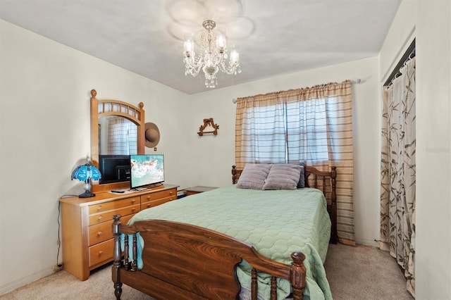 bedroom with light colored carpet, a closet, and a notable chandelier