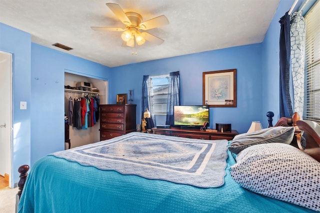 bedroom featuring ceiling fan, carpet floors, a textured ceiling, and a closet