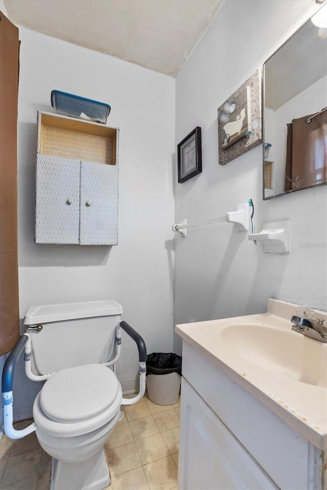 bathroom featuring tile patterned floors, vanity, and toilet