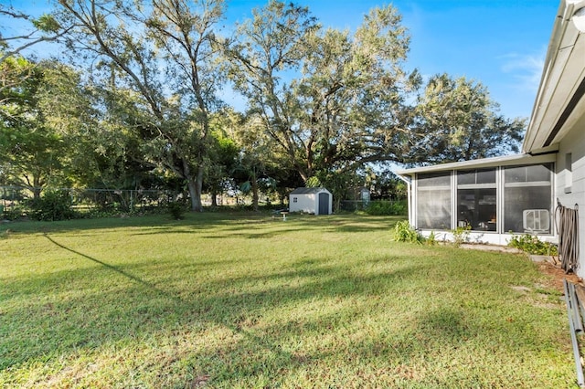 view of yard featuring a sunroom and a shed