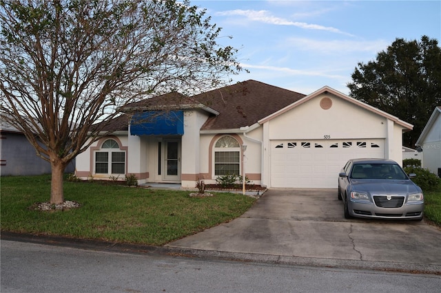 single story home with a front yard and a garage