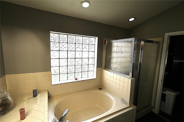 bathroom featuring independent shower and bath