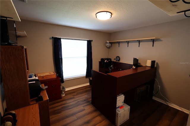 office space featuring dark wood-type flooring and a textured ceiling