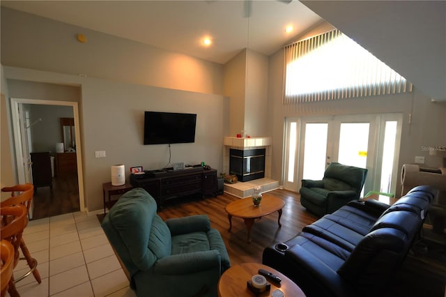 living room with a towering ceiling and light tile patterned flooring