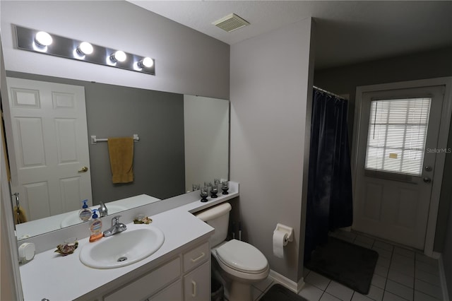 bathroom featuring vanity, toilet, and tile patterned floors