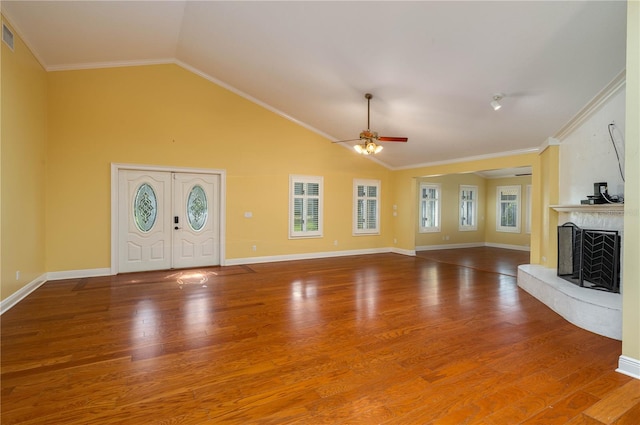 unfurnished living room featuring crown molding, wood-type flooring, and vaulted ceiling