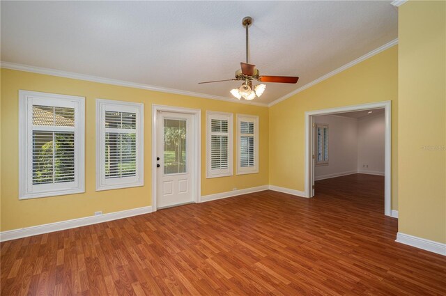 empty room with ornamental molding, hardwood / wood-style flooring, and a healthy amount of sunlight