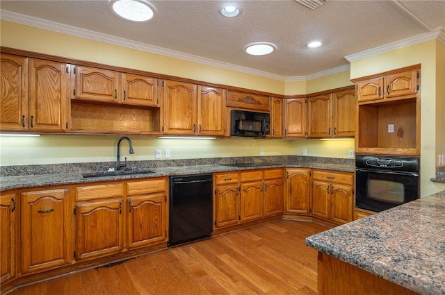 kitchen with a textured ceiling, light hardwood / wood-style flooring, black appliances, crown molding, and sink