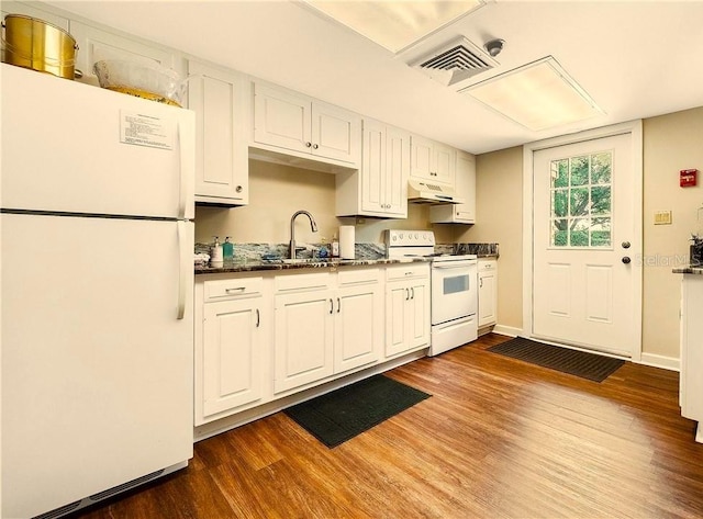 kitchen featuring white cabinets, dark hardwood / wood-style flooring, premium range hood, sink, and white appliances