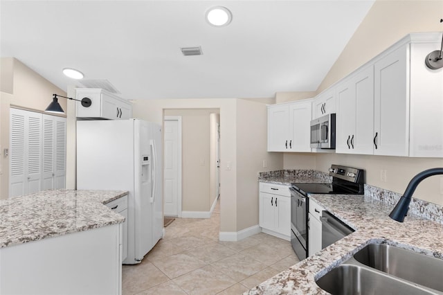 kitchen featuring light stone counters, stainless steel appliances, sink, and white cabinets