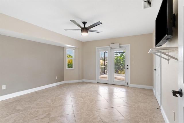 unfurnished room with ceiling fan and light tile patterned floors