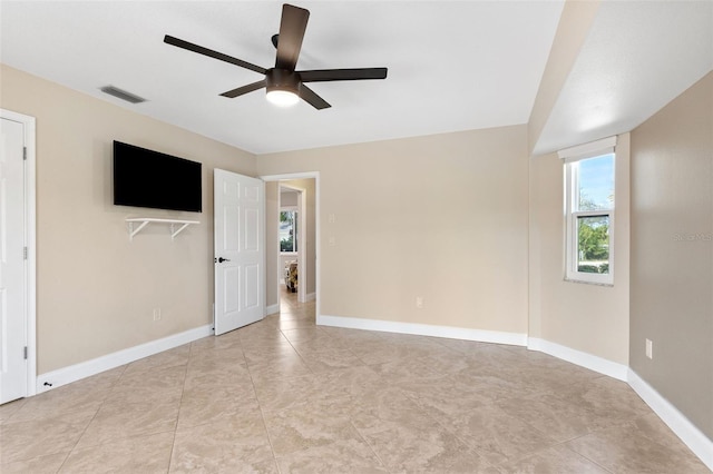 interior space with ceiling fan