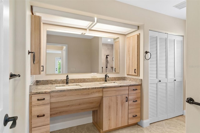 bathroom with vanity and tile patterned flooring