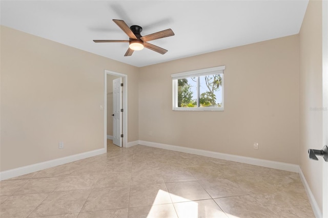 spare room with ceiling fan and light tile patterned flooring