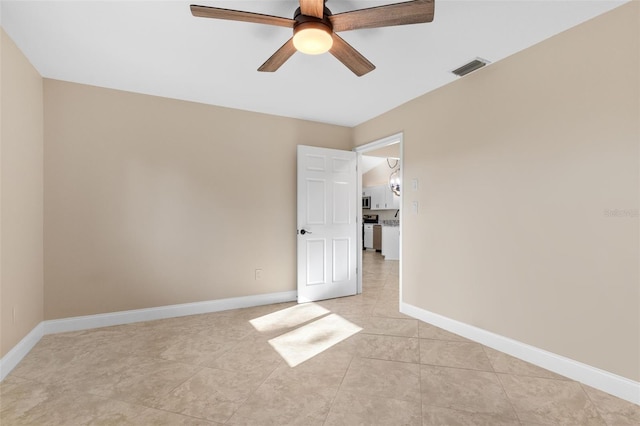 unfurnished bedroom with light tile patterned flooring and ceiling fan