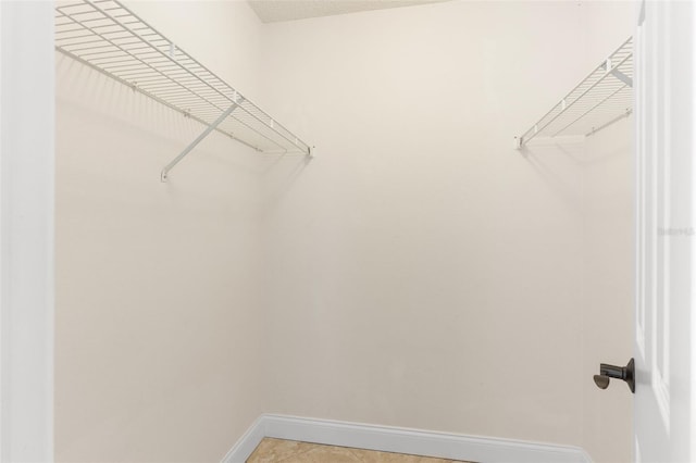 walk in closet featuring light tile patterned floors