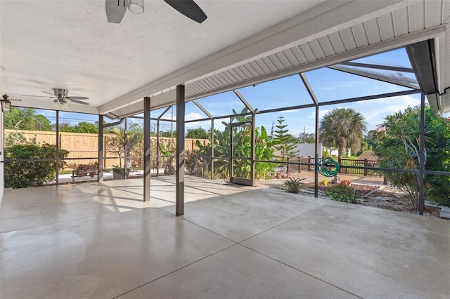 unfurnished sunroom featuring ceiling fan