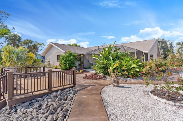 rear view of property featuring a wooden deck