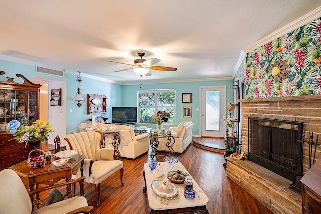 living room with ornamental molding, ceiling fan, a fireplace, and dark hardwood / wood-style flooring