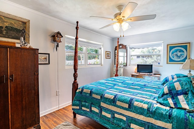 bedroom with crown molding, hardwood / wood-style flooring, multiple windows, and ceiling fan