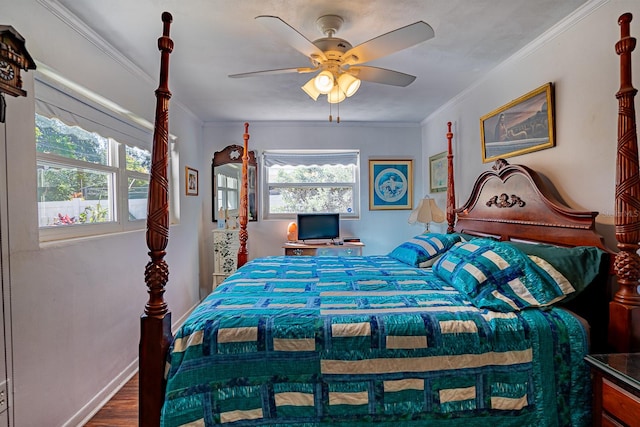 bedroom with ceiling fan, ornamental molding, multiple windows, and hardwood / wood-style floors