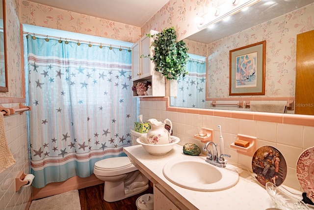 bathroom with vanity, toilet, hardwood / wood-style flooring, and tile walls