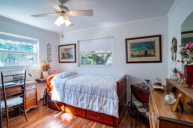 bedroom featuring ornamental molding, hardwood / wood-style flooring, and ceiling fan