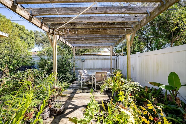 view of patio / terrace featuring a wooden deck and a pergola