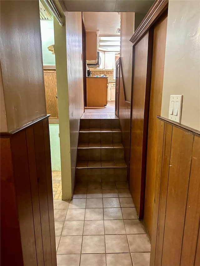 stairway with tile patterned floors