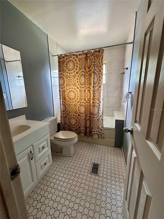 full bathroom with toilet, shower / bathtub combination with curtain, vanity, and tile patterned floors