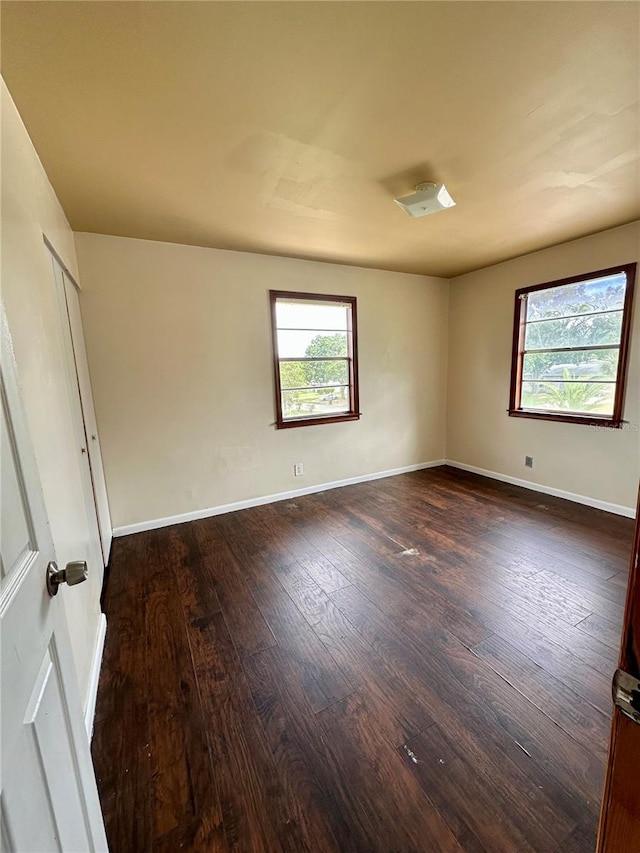 unfurnished room featuring dark hardwood / wood-style flooring