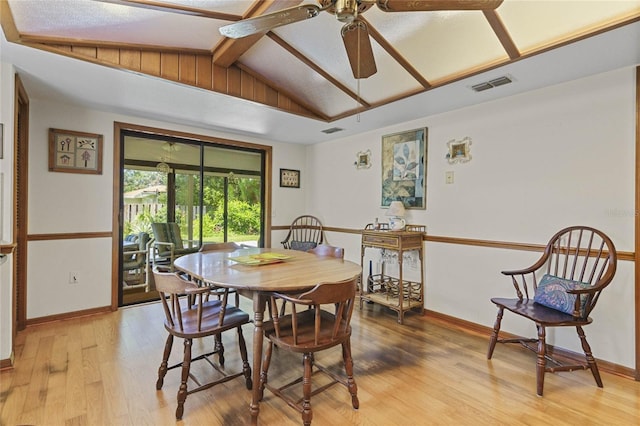 dining room with vaulted ceiling with beams, light wood-type flooring, and ceiling fan