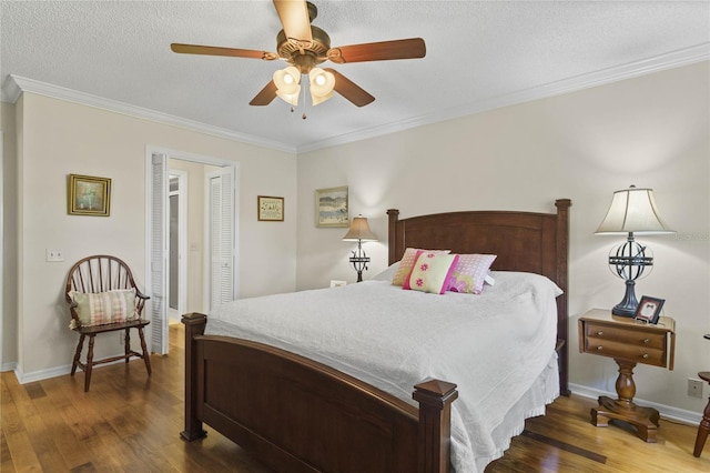 bedroom with ceiling fan, crown molding, a textured ceiling, and dark hardwood / wood-style floors