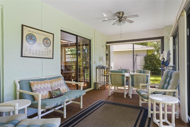 sunroom / solarium featuring a healthy amount of sunlight and ceiling fan