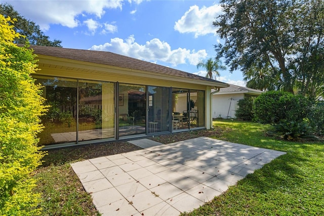 back of property featuring a patio and a yard