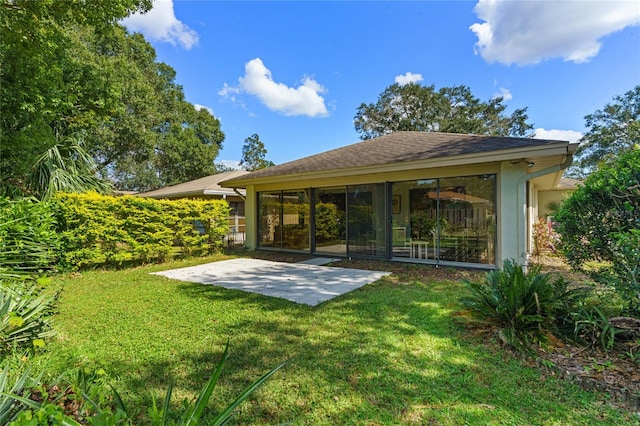 back of house with a patio and a yard