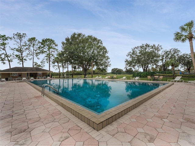 view of swimming pool with a patio