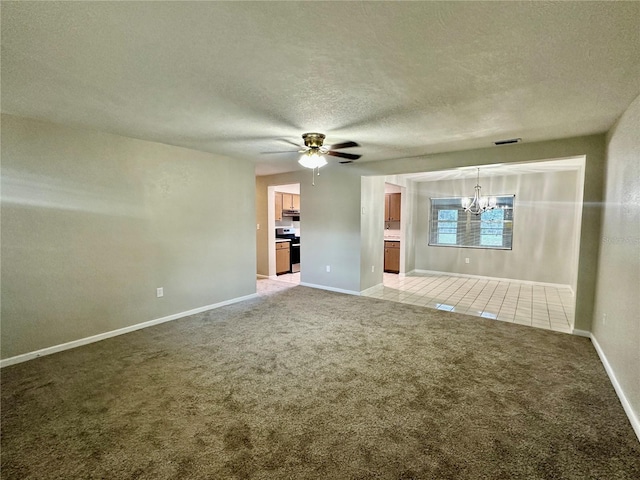 unfurnished living room featuring carpet flooring, a textured ceiling, and ceiling fan with notable chandelier