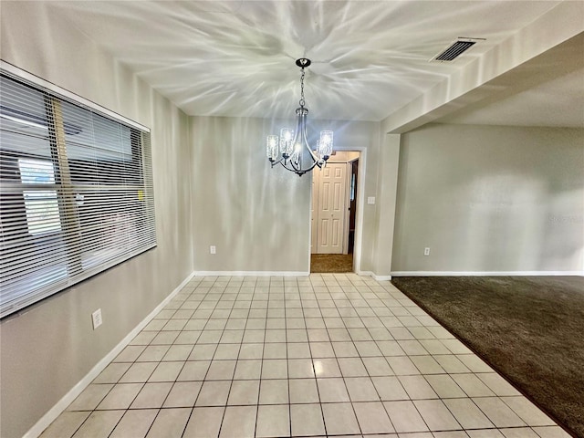 unfurnished dining area featuring a chandelier and light colored carpet