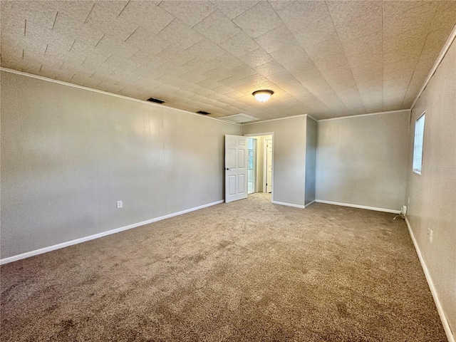 spare room featuring carpet flooring and ornamental molding