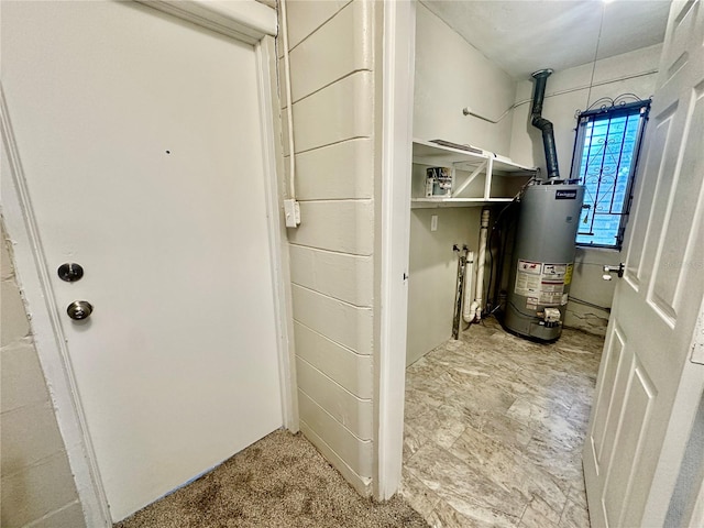 utility room featuring water heater