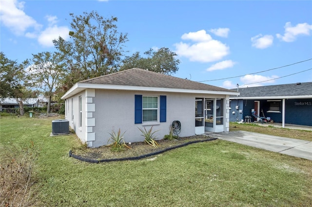 ranch-style house featuring a carport, central AC, and a front yard