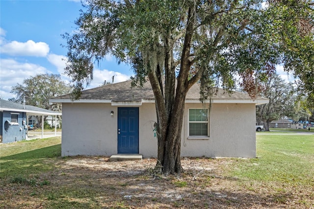 back of property featuring a yard