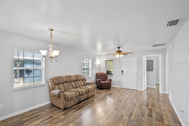 living room featuring dark hardwood / wood-style flooring, ceiling fan with notable chandelier, and a textured ceiling