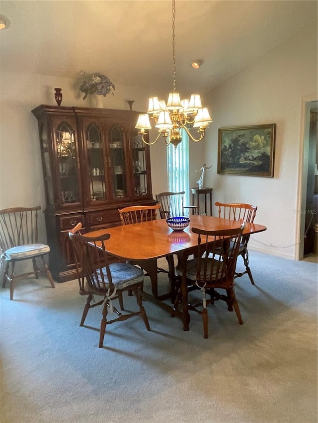 carpeted dining space featuring lofted ceiling and an inviting chandelier