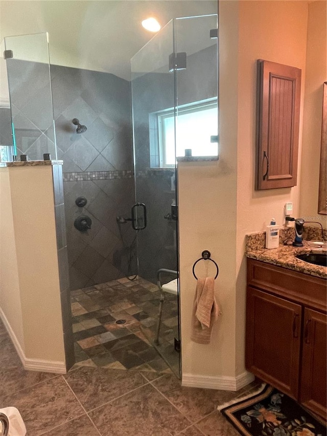 bathroom with vanity, tile patterned flooring, and an enclosed shower