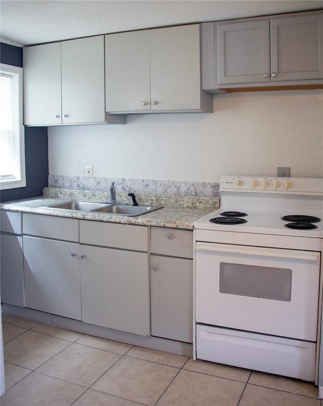 kitchen featuring light tile patterned flooring, sink, gray cabinets, and electric stove