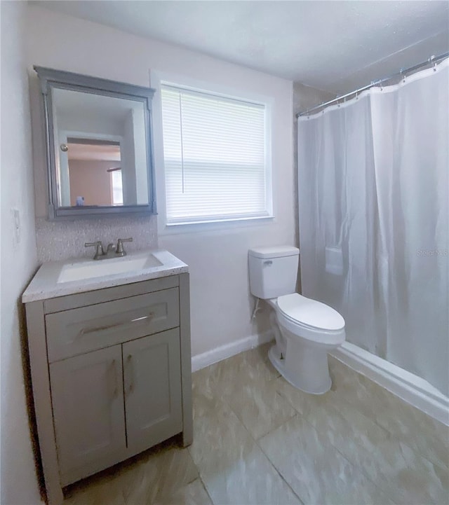 bathroom with vanity, toilet, and walk in shower