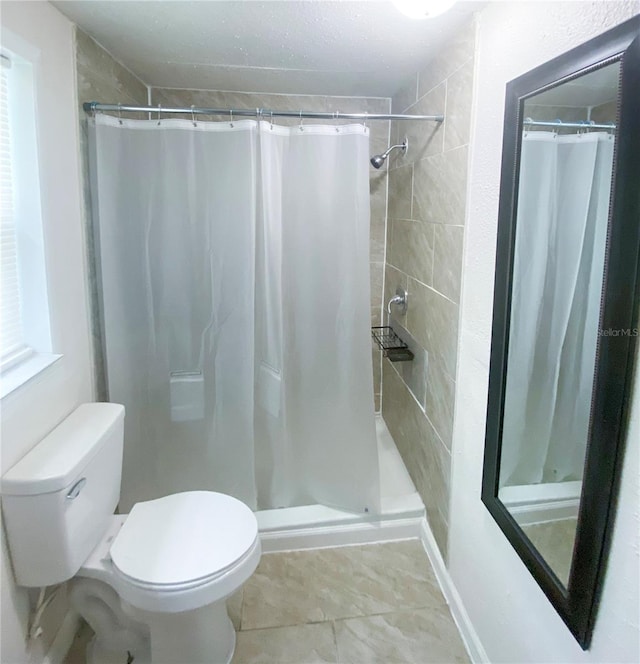 bathroom with curtained shower and toilet