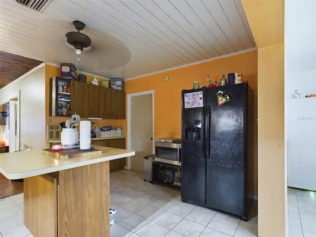 kitchen with black refrigerator with ice dispenser, light tile patterned flooring, and wooden ceiling